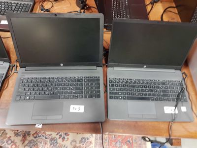 two laptops that are sitting on a table