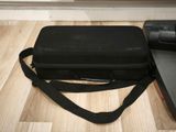 a black case sitting on a wooden floor next to a laptop