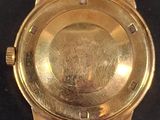an image of a close up of a watch on a black surface