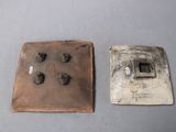 two pieces of metal that have been placed on a table