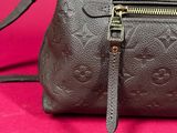 a close up of a brown handbag on a pink background