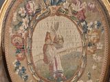 an old chair with a picture of a man and a woman on it
