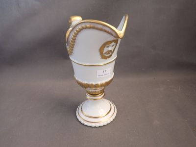 a white vase with a gold decoration on it