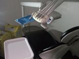 a dentist chair with a tray on it in a room