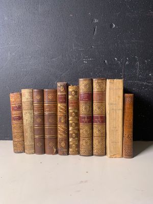 une rangée de vieux livres posés sur une table blanche