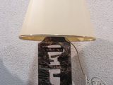 a lamp that is sitting on a table with a lamp shade on it