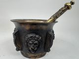 brass mortar with lion head and pestula in it