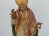 a statue of a man with a crown and a cross