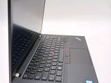 a black laptop with a red button on the keyboard