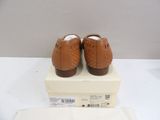 a box with a pair of brown shoes on it