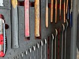 many tools that are hanging on the wall in the garage