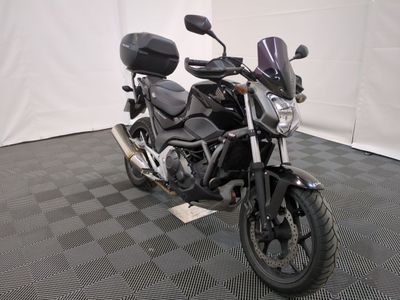 a motorcycle that is parked on a black and white checkered floor