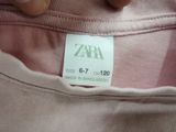 a label on the back of a shirt that says zara