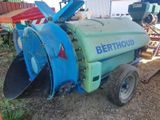 a blue and green machine that is sitting in the dirt