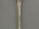 silver spoon with a spoon handle on a white surface