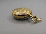 a gold locke with a chain hanging from it ' s side