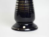 a black vase with a striped design on it