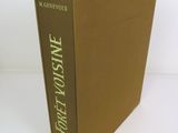 the front cover of a brown book with green writing on it
