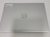 the back of a silver laptop computer sitting on top of a white table
