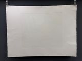 a white piece of paper hanging on a black wall