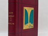 the book is red with gold trimming and a picture of a man in a boat