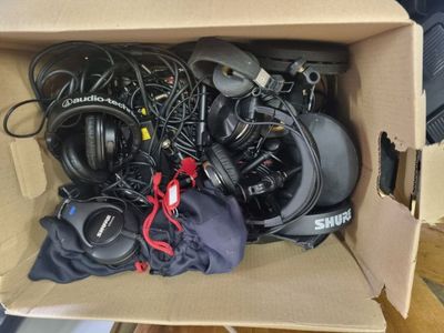 a cardboard box filled with headphones and other electronics