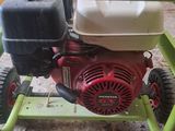 a small green cart with a small engine on it