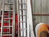 a ladder leaning up against a wall next to a pile of other items