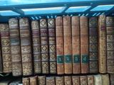 a lot of old books on a shelf in the room