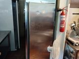 a stainless steel refrigerator in the corner of a kitchen