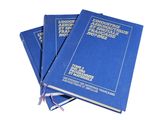 three blue books stacked on top of each other on a white surface