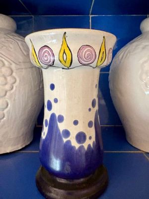 trois vases posés sur un sol en carrelage bleu