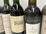 several bottles of wine are lined up on a white surface
