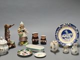 many different types of porcelain items displayed on the table
