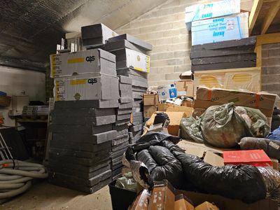 a pile of boxes and other items in a room