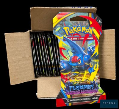 a box of pokemon trading cards sitting on top of a cardboard box