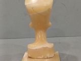 marble sculpture of a cup on a pedestal on a gray surface