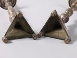 pair of antique brass candlesticks on a white background