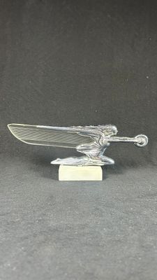 an image of a silver statue of a man on a skateboard