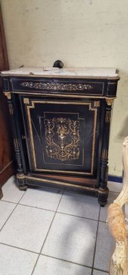 a black cabinet with a gold design on it