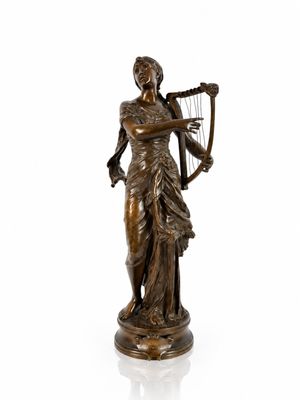 a bronze statue of a woman holding a harp