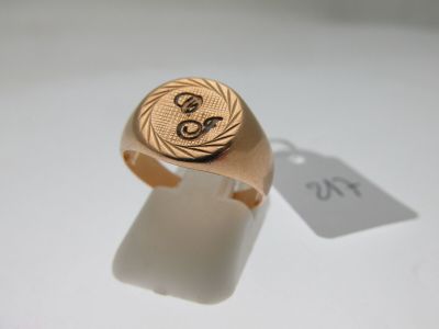 an image of a gold signet ring with the letter s on it