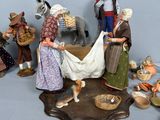 many figurines of people and animals on a table