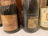 several bottles of wine are lined up on a counter