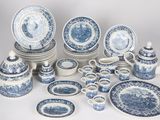 many blue and white plates and cups and saucers