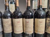 several bottles of wine are lined up on a table