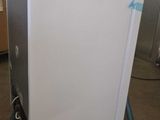 an image of a white refrigerator in a room