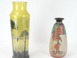 two vases sitting side by side on a white surface