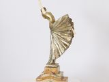 statue of a female dancer on a marble base with a white background