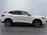 the white suv is parked in a room with a gray floor